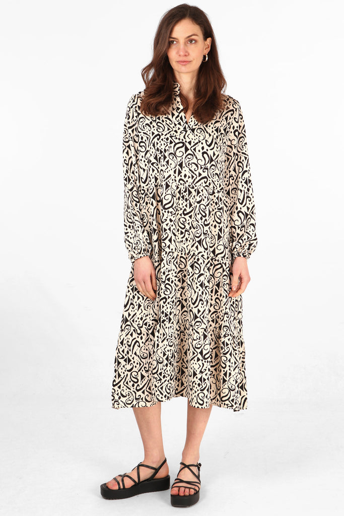 midi tiered dress with long sleeves and an all over cream and black aztec pattern