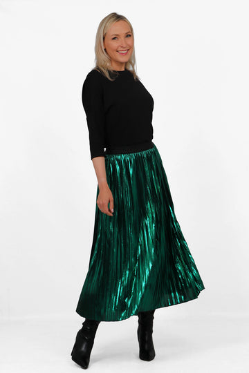 model wearing a green pleated metallic foil midi skirt with a black glitter elasticated waistband