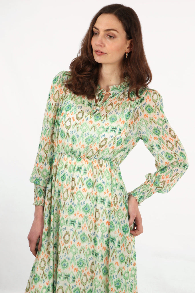 green ikat pattern shirred shoulder long sleeve dress with neck tie