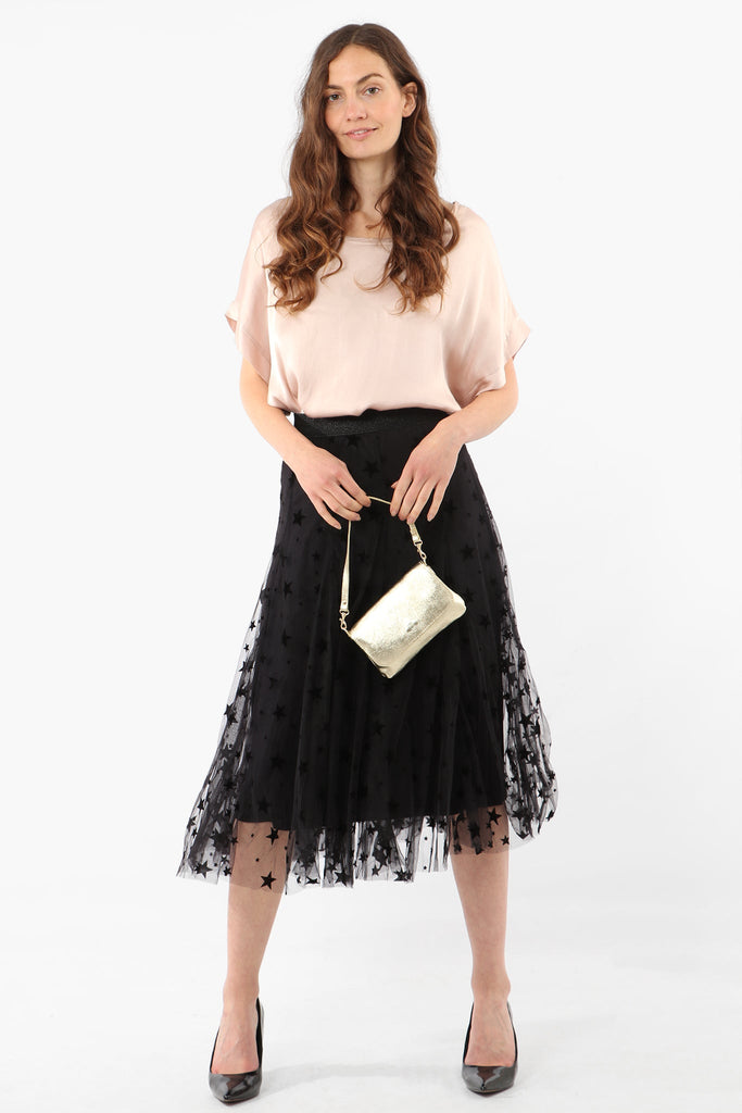 model wearing a black midi tulle skirt with an all over star print pattern