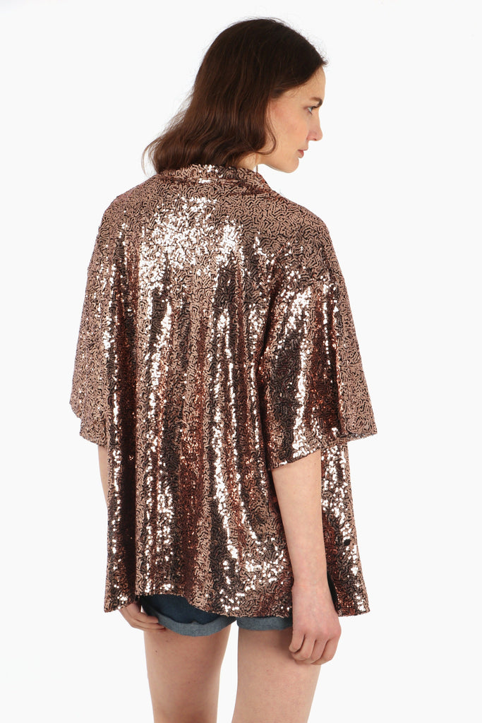 model showing the back of the sequin kimono top, showing an all over sparkly effect