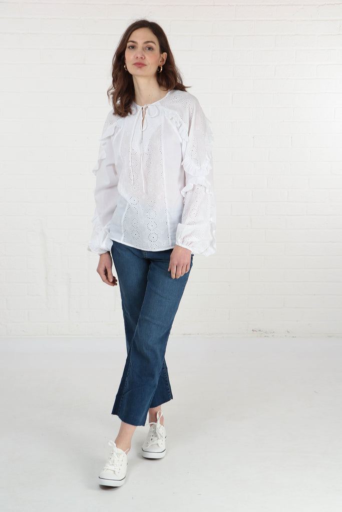 model wearing a long sleeve white cotton summer blouse with a grandad collar 