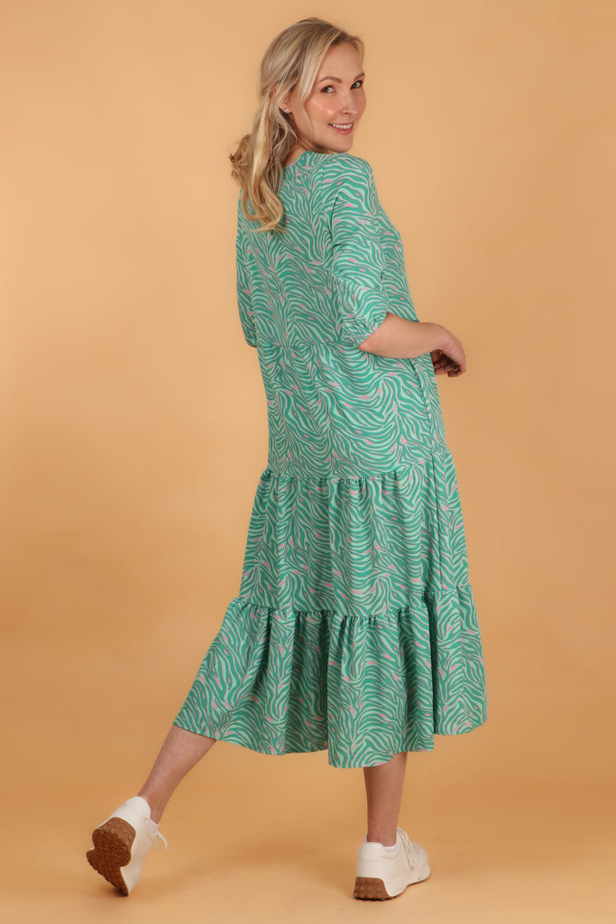 model showing the back of the dress with the tiered hem design