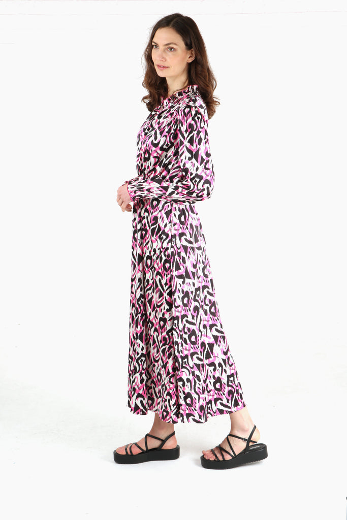 model wearing a long midi dress with an elasticated waist with an all over pink ikat pattern