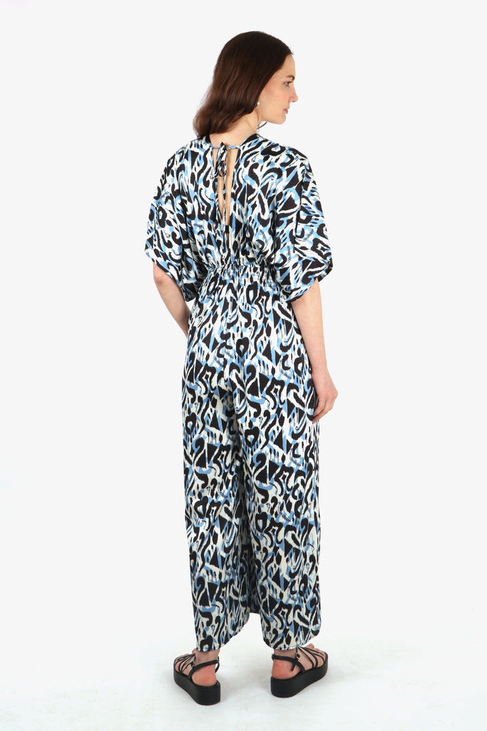 model showing the back of the jumpsuit with the neck tie feature at the back