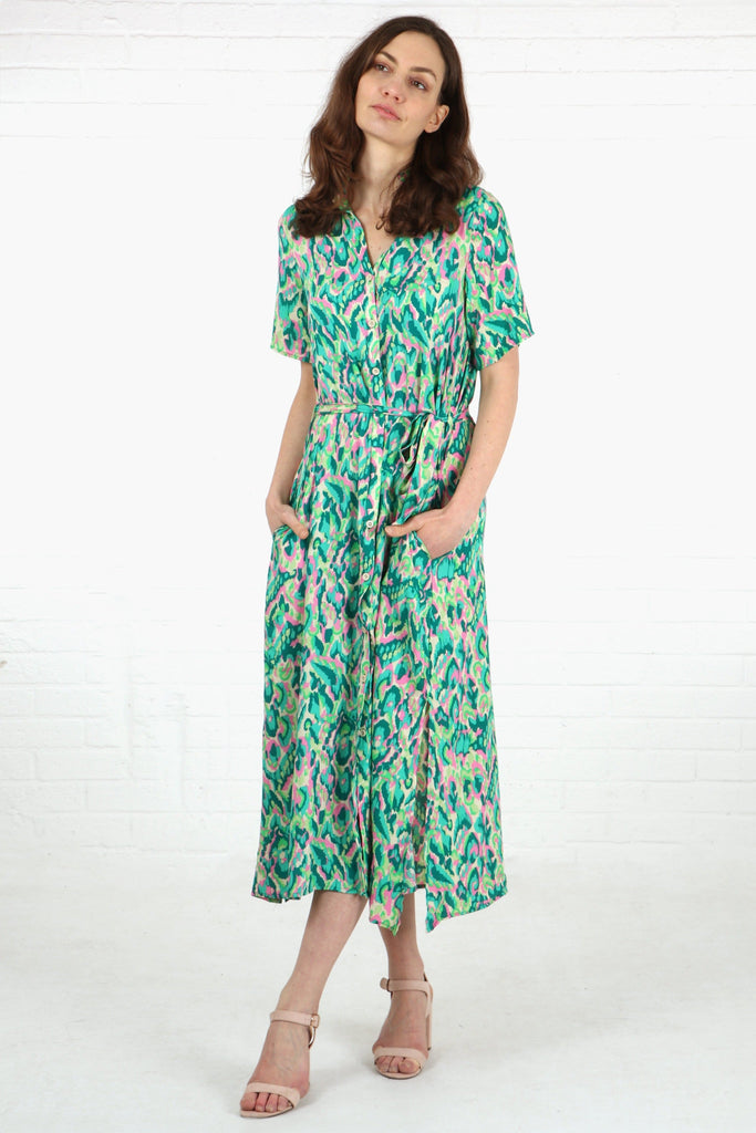 model wearing a green midi shirt dress with a button down front, waist belt and short sleeves