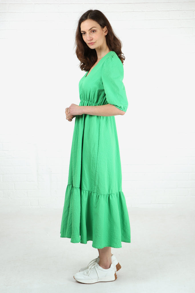 model wearing a short sleeve green midaxi tiered dress