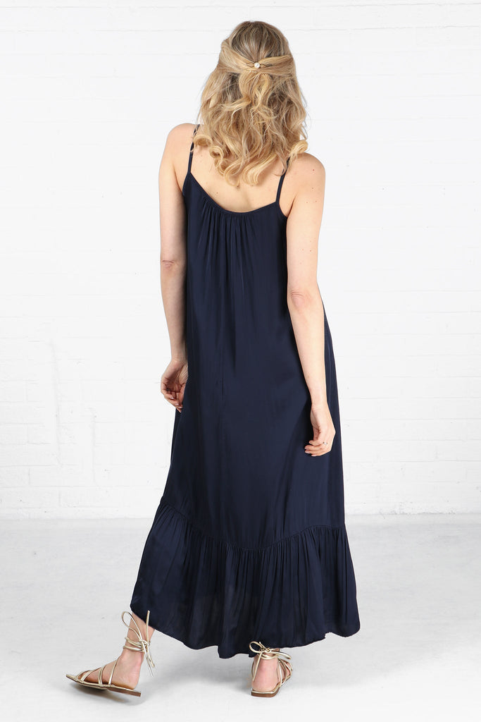 model showing the back of the tiered navy blue maxi dress 