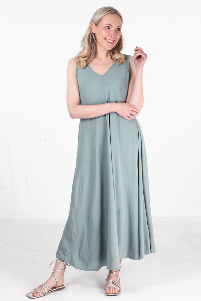 model wearing a long loose fitting floaty maxi dress in green