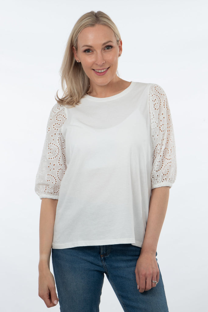 model wearing a white cotton tshirt with puff broderie anglaise sleeves
