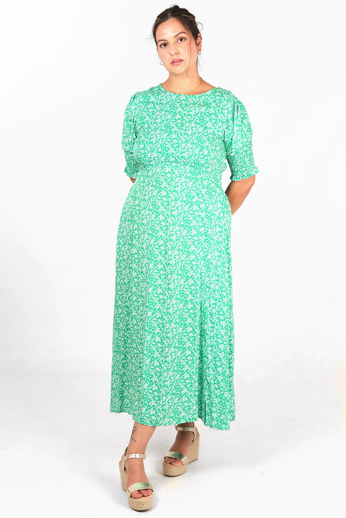 green floral print midaxi length tea dress with round neck and elbow length shirred cuff sleeves