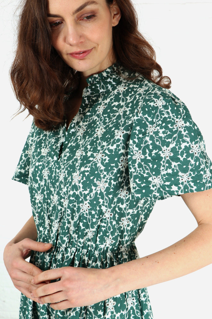 close up of the green and white pattern and the floral broderie anglaise detail