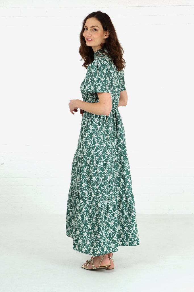 model showing a side view of the long tiered dress, showing that the hem line is maxi all the way around