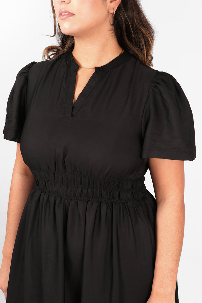 close up of the elasticated smocked waist and short sleeves