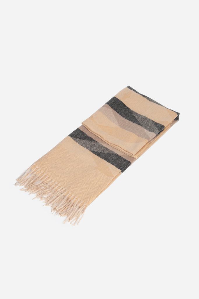 folded and laying flat showing the aztec pattern and tassel trim fringe scarf