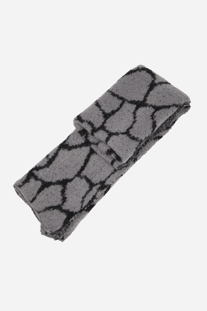 folded scarf showing the giraffe print pattern