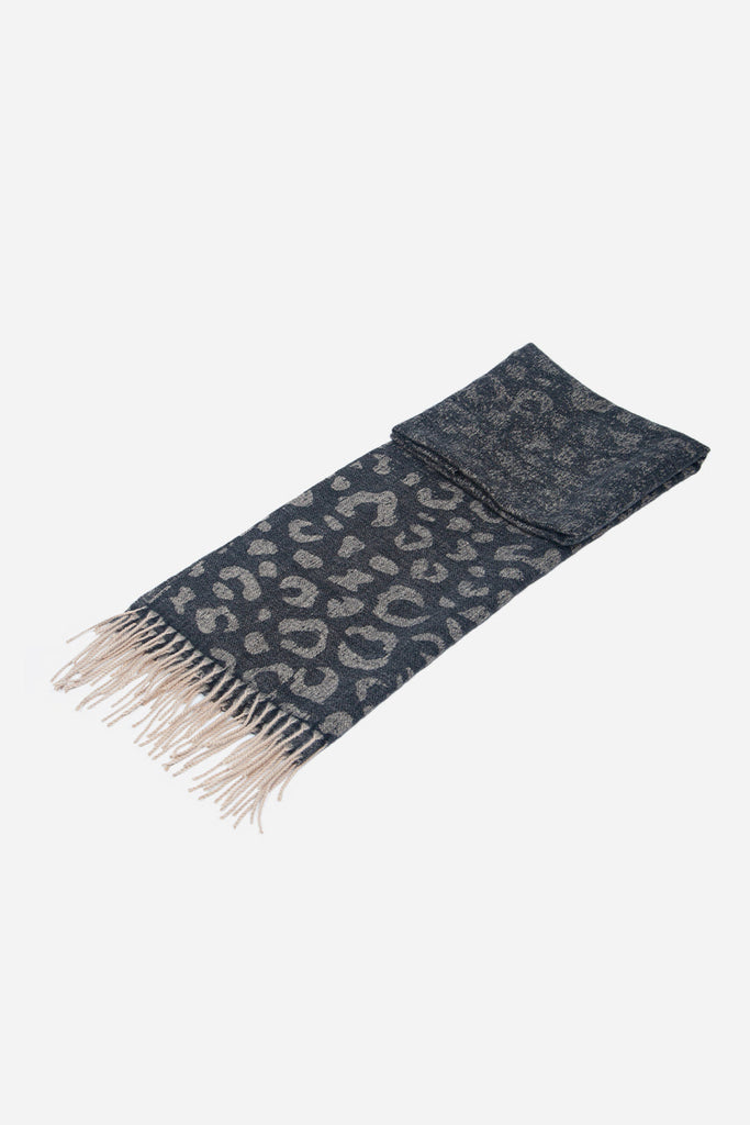 scarf laying folded flat showing the black leopard print pattern