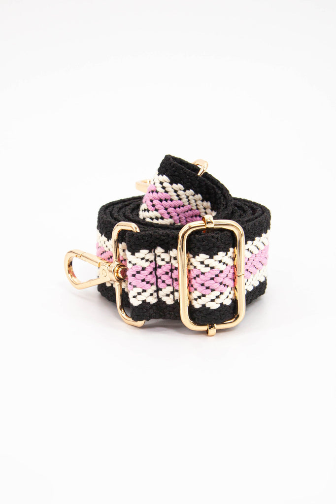close up of the gold adjustment buckle on the black and pink contrasting chevron stripe bag strap