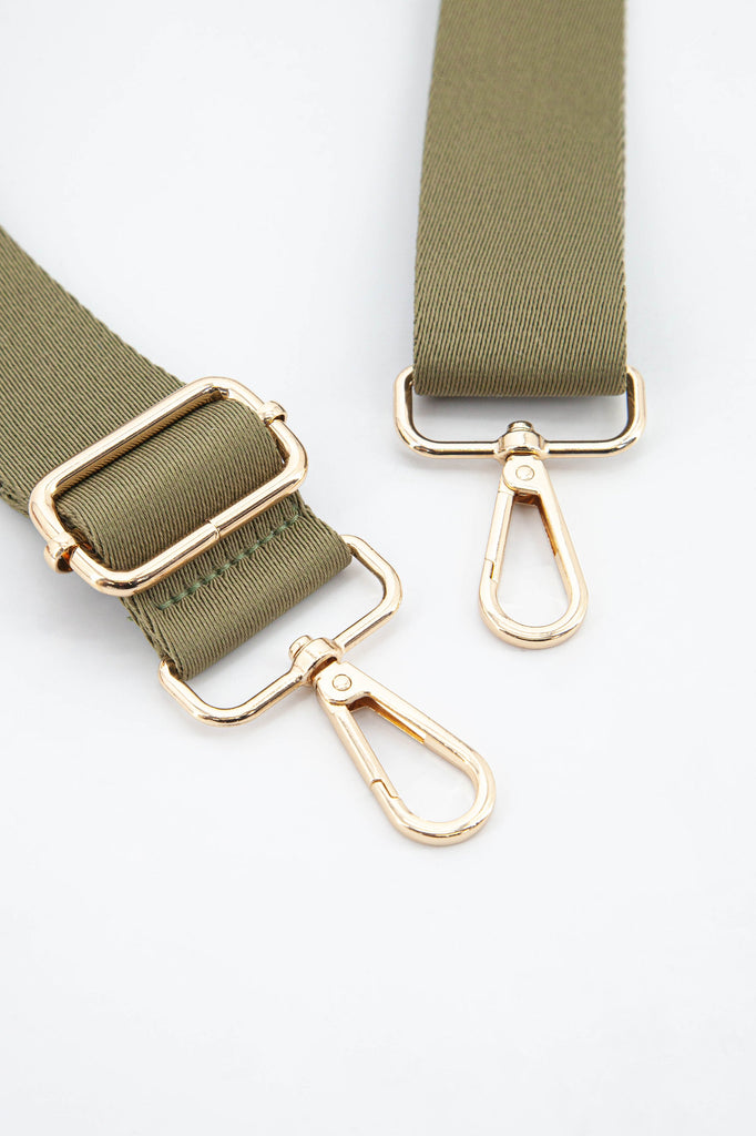 close up of the gold snap hook attachments and the khaki colour of the strap