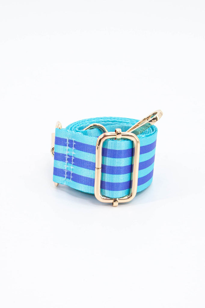 close up of the alternating blue stripe pattern and gold adjustment buckle