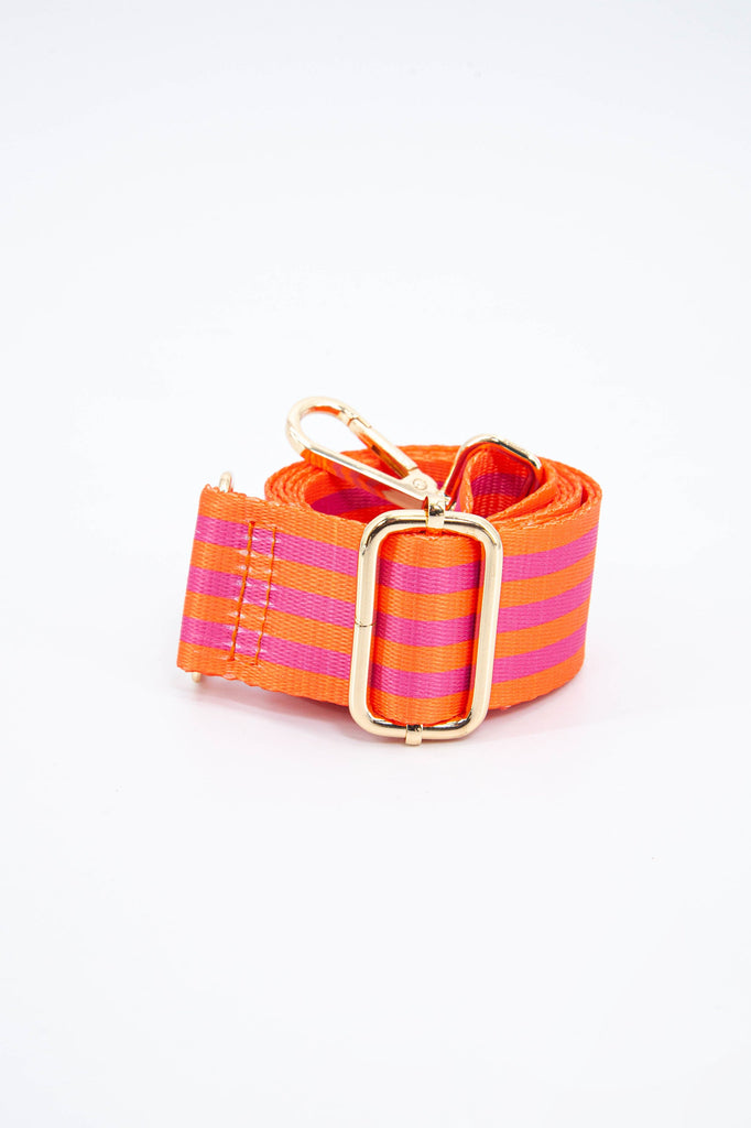 close up of the alternating orange and pink stripe pattern and gold adjustment buckle