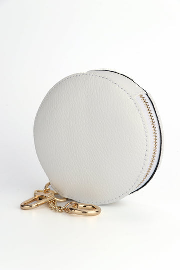white leather round coin purse with clip on keyring attachments and a gold zip closure