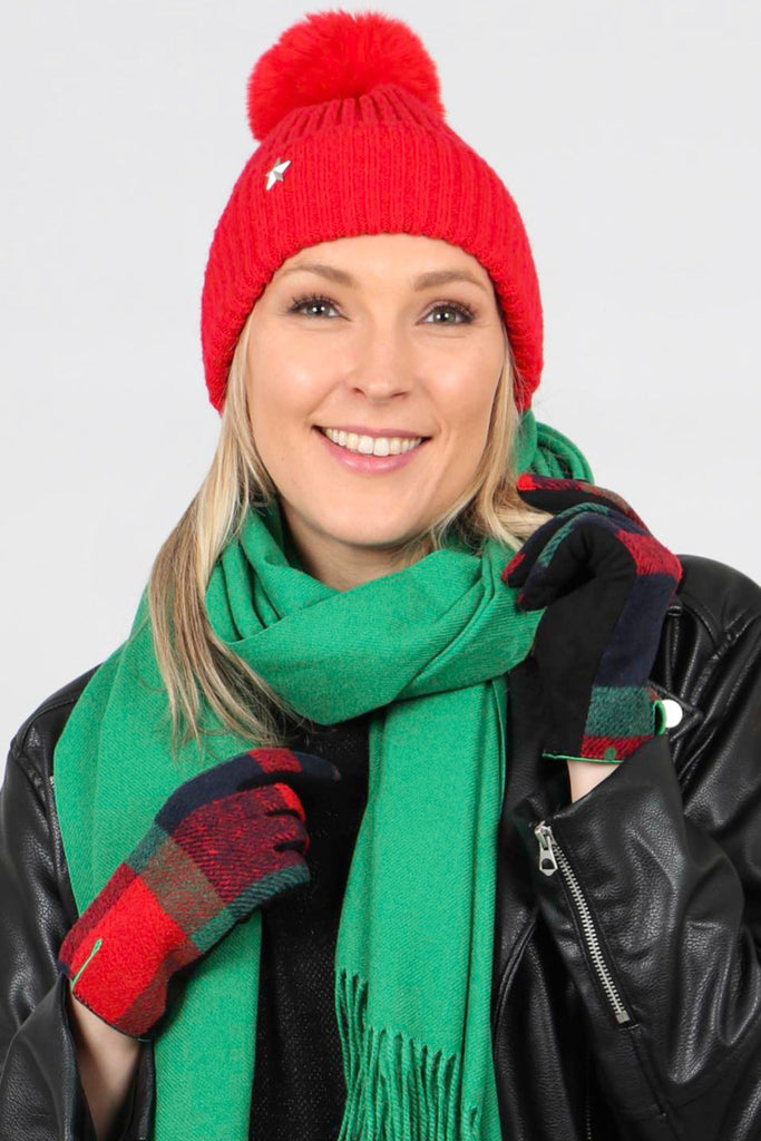 model wearing red and green tartan winter gloves and matching accessories