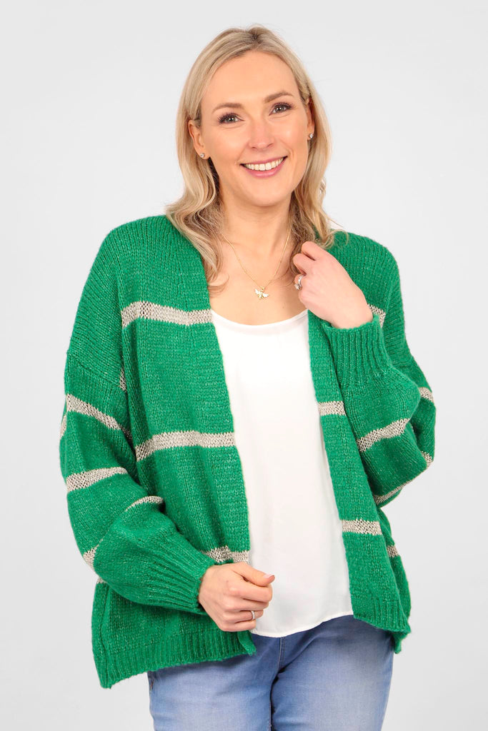 model wearing a green open front cardigan with a gold glitter stripe