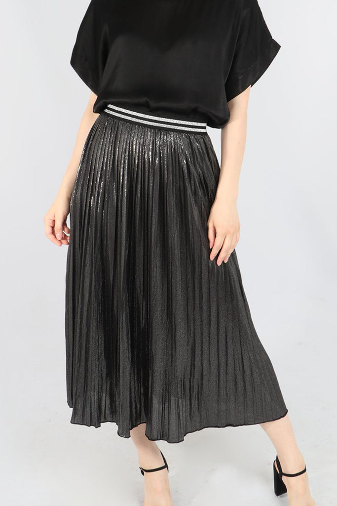 model wearing a black and silver metallic pleated foil skirt with glitter waistbandc