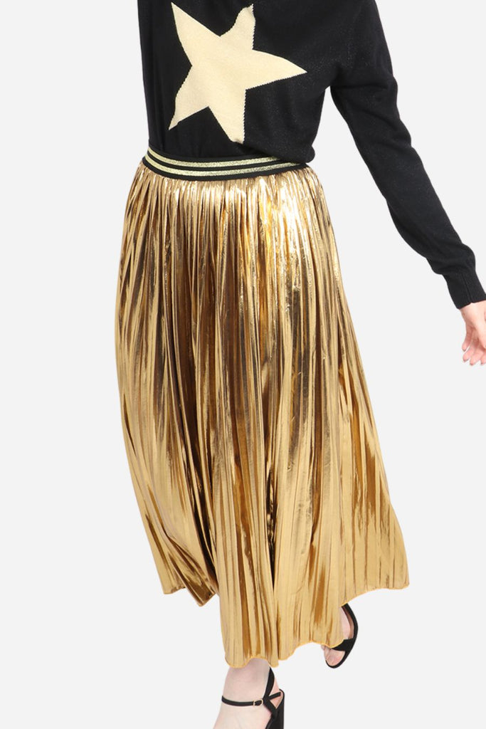 model wearing a gold foil pleated midi skirt with gold glitter stripe waistband