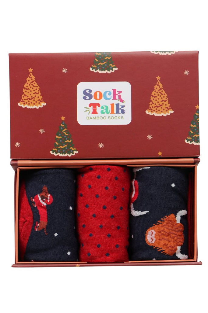 red gift box featruing christmas trees with three pairs of novelty xmas animal socks