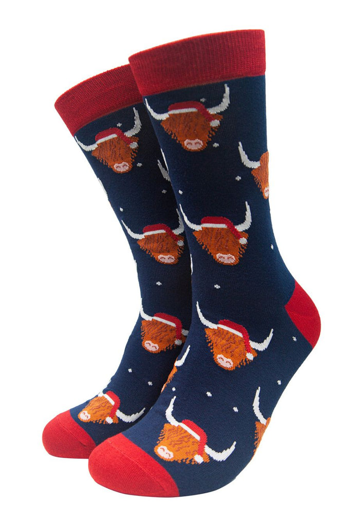 navy blue dress socks featuring highland cows wearing santa hats