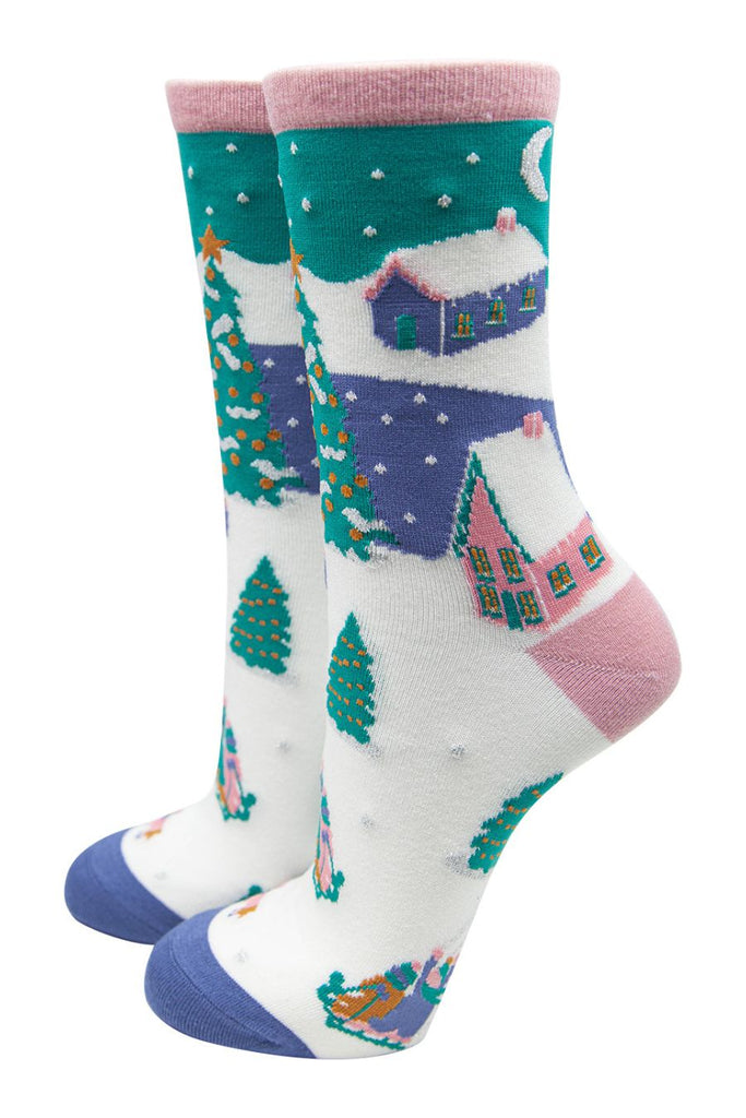 multicoloured ankle socks designed to look like a snow scene with trees, chalets and people on sleighs
