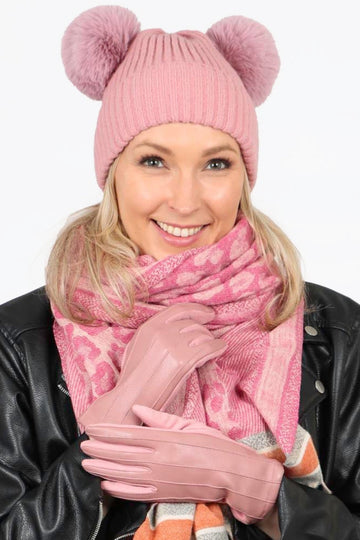 model wearing pink ribbed faux leather gloves with matching winter accessories