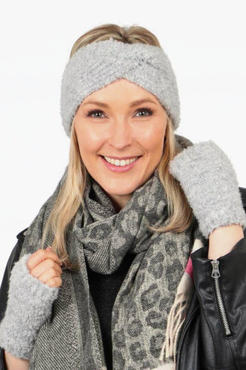 model wearing light grey fingerless wrist warmer gloves and a matching grey headwarmer