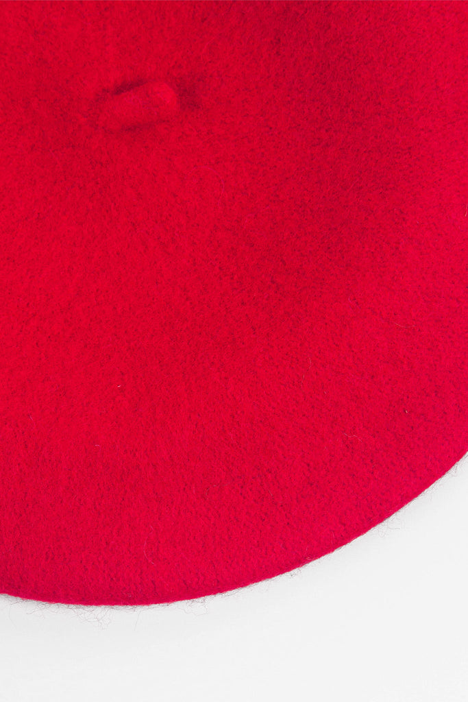 close up of the wool rich fabric and vibrant red colour of the beret