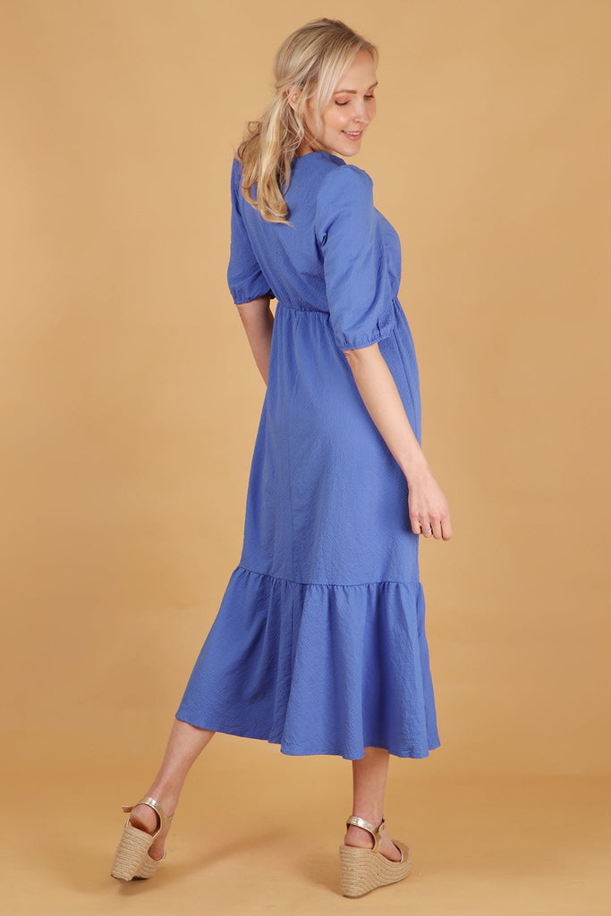 model showing the back of the dress with the all over solid blue colour