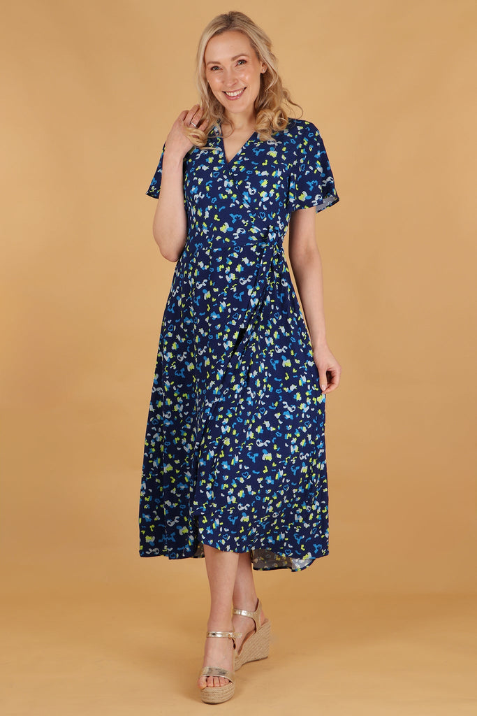 model wearing a midi length short sleeve wrap dress with an all over blue abstract animal print