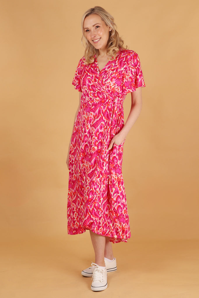 model showing that the short sleeve pink wrap dress has pockets